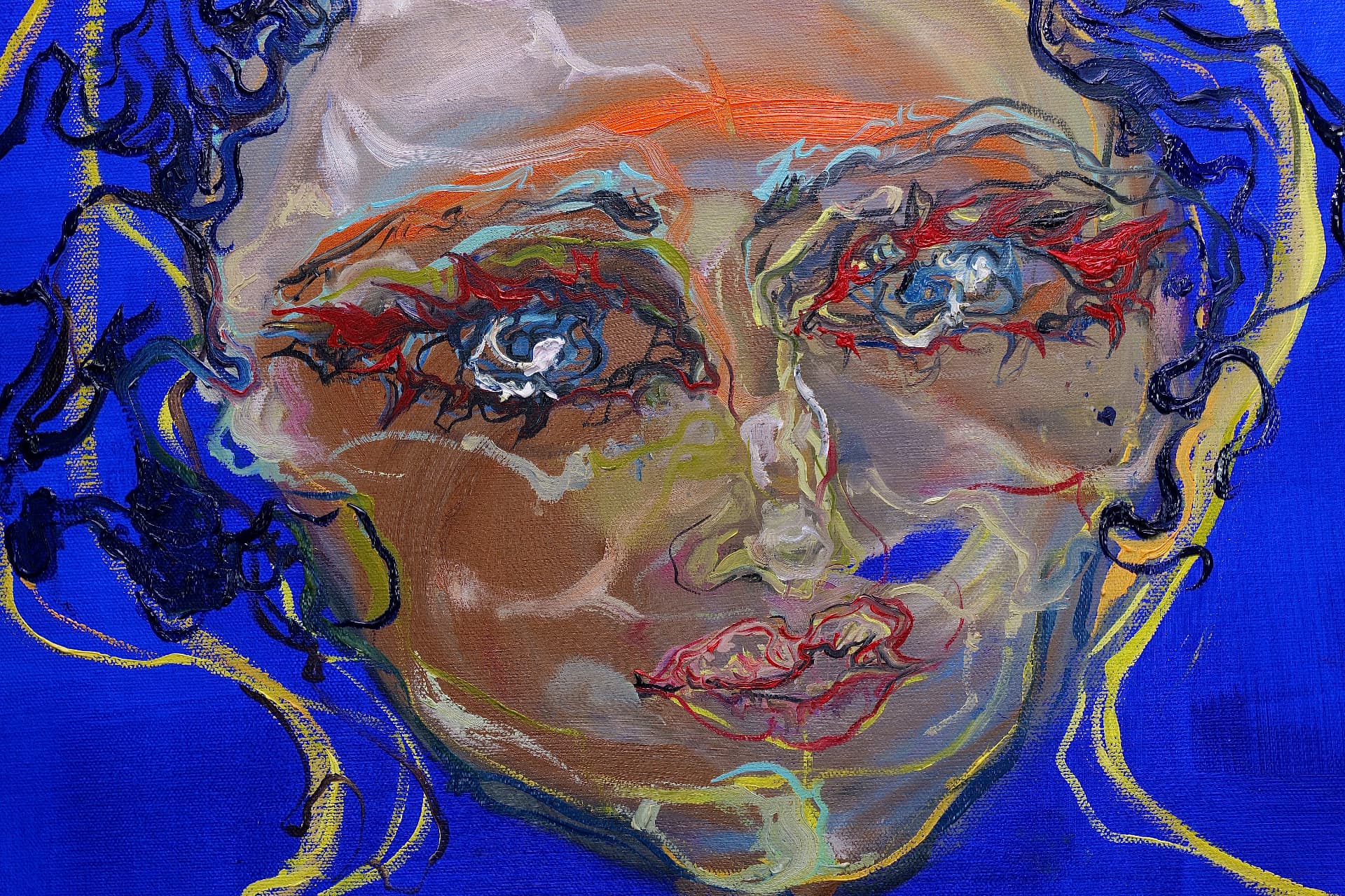 Firemark — the face at close range, with orange across the brow and red marks around both eyes.